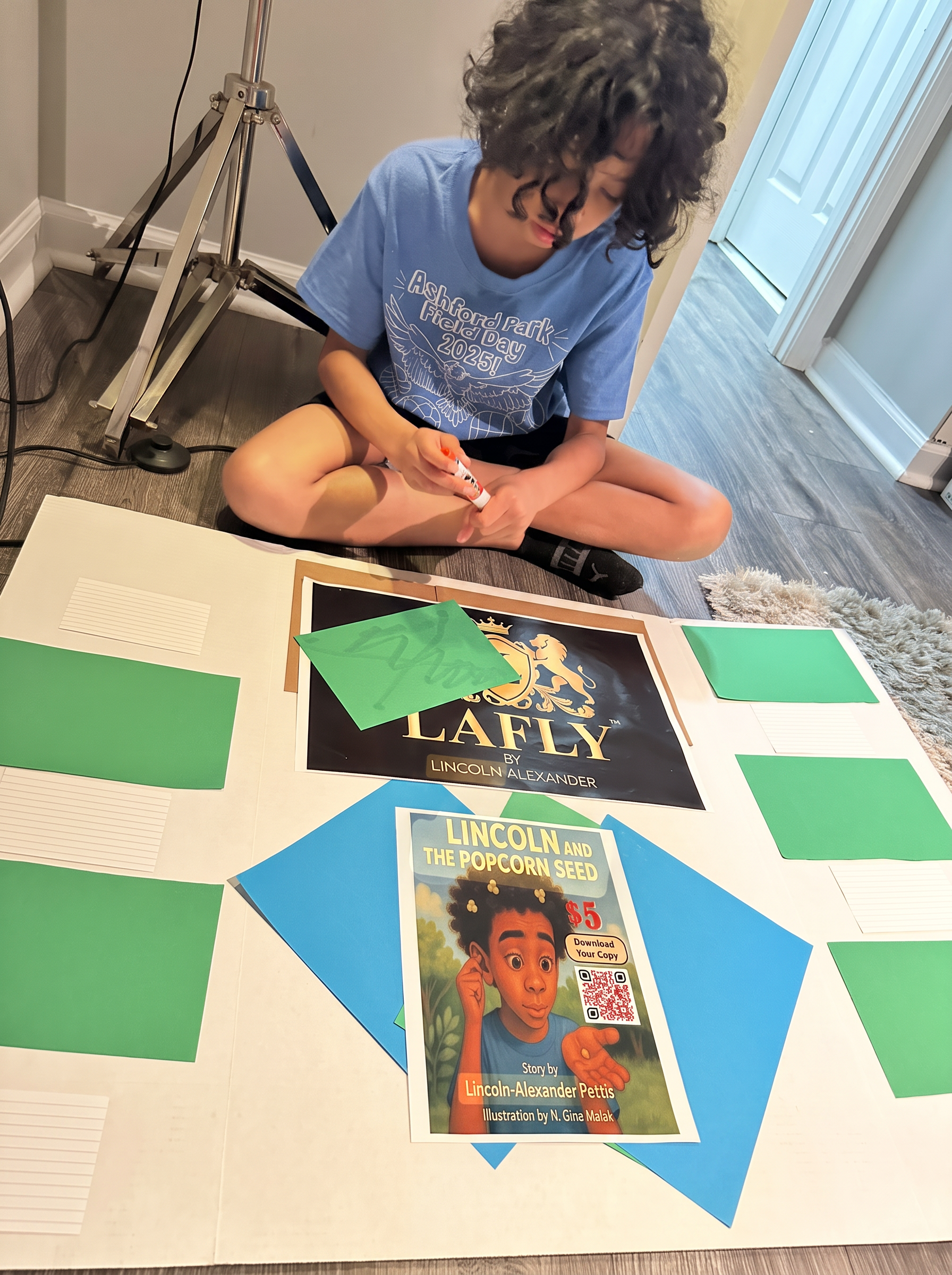 Lincoln assembling his market day project display featuring the Popcorn Seed book